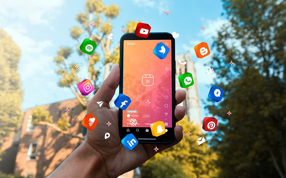 Phone surrounded by graphic icons for different social media apps